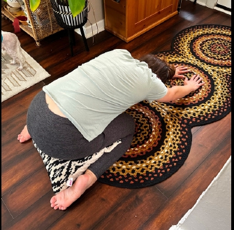 Child's pose with pillow exercise demonstration